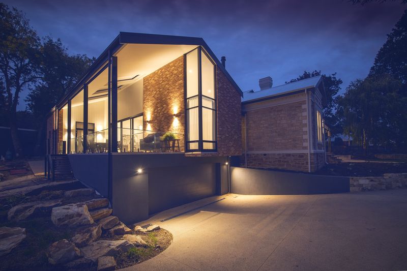 Modern home lit up at dusk